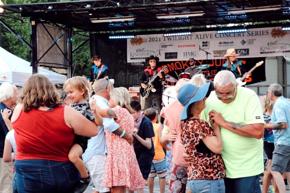 families dancing with band playing in background