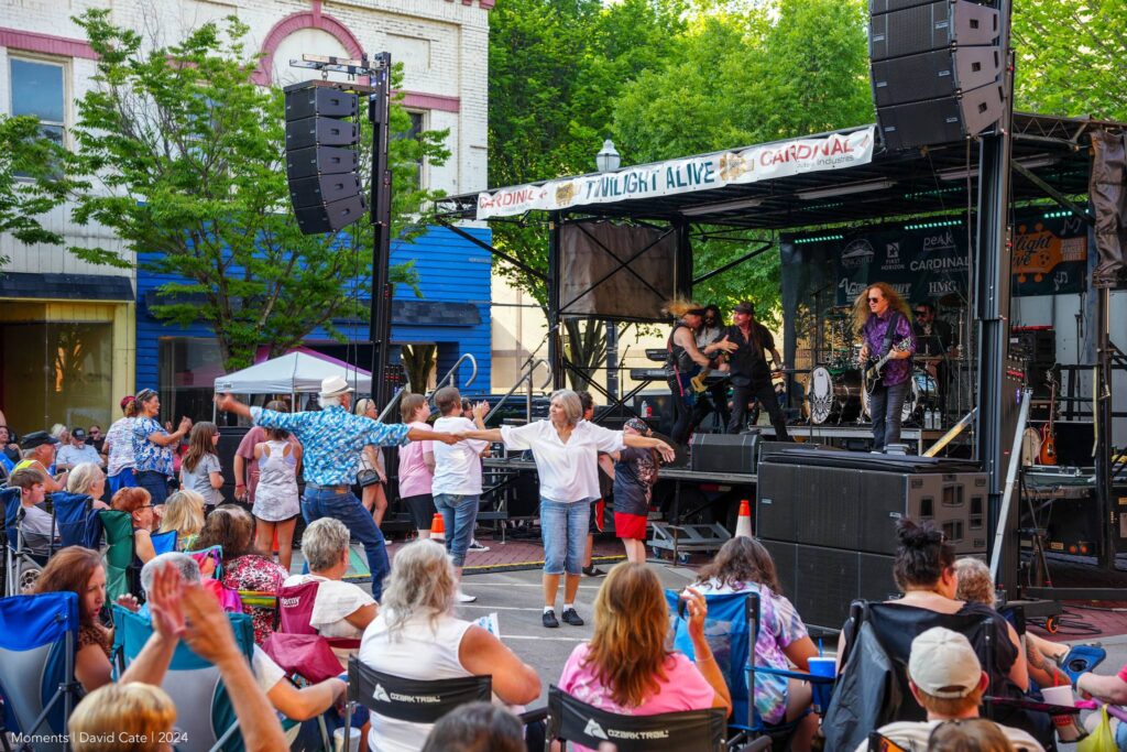 people dancing in front of crowd on street