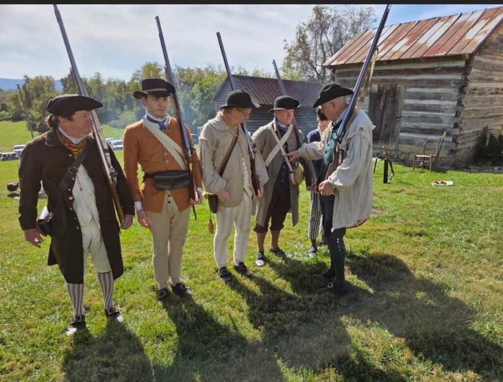 men dressed in old militia outfits for reenactment