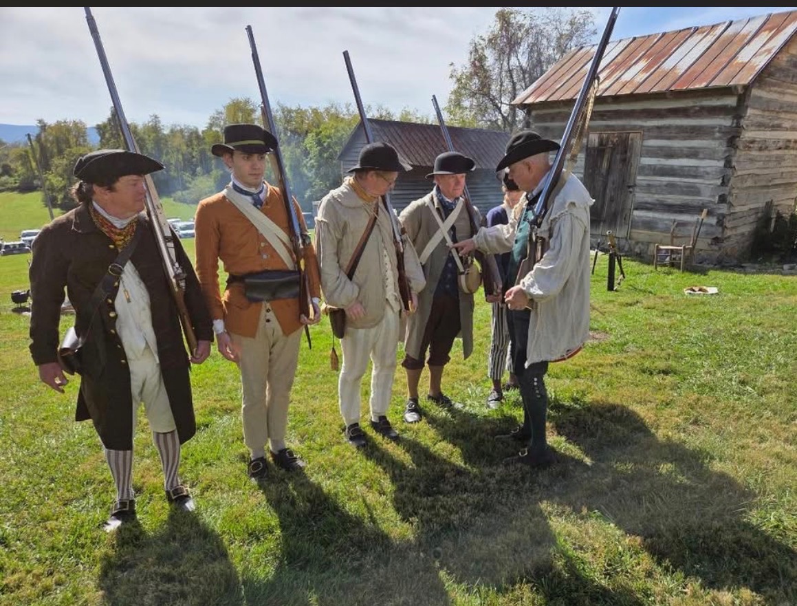 men dressed in old militia outfits for reenactment