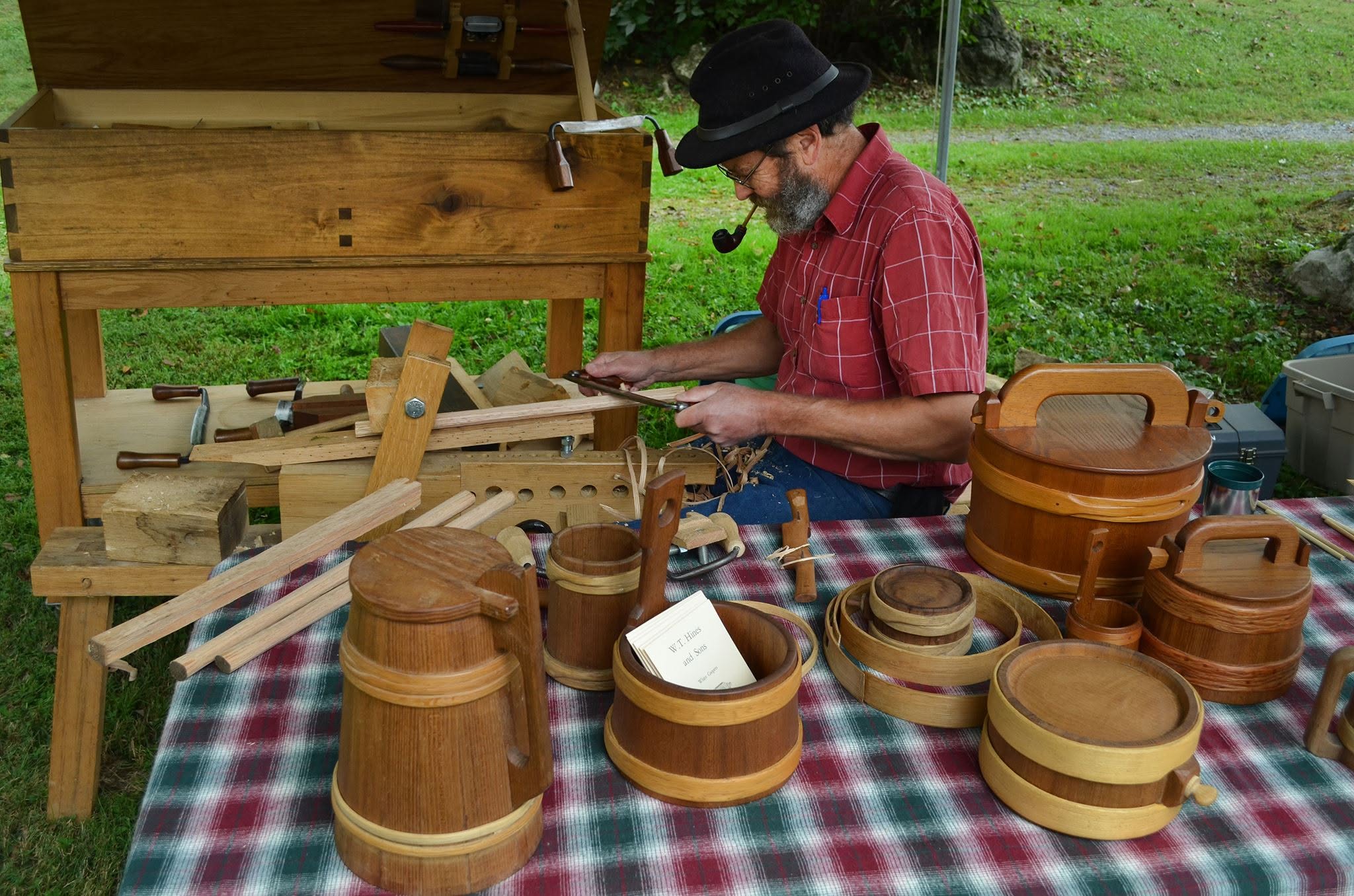 wooden basket maker with pipe at fall festival